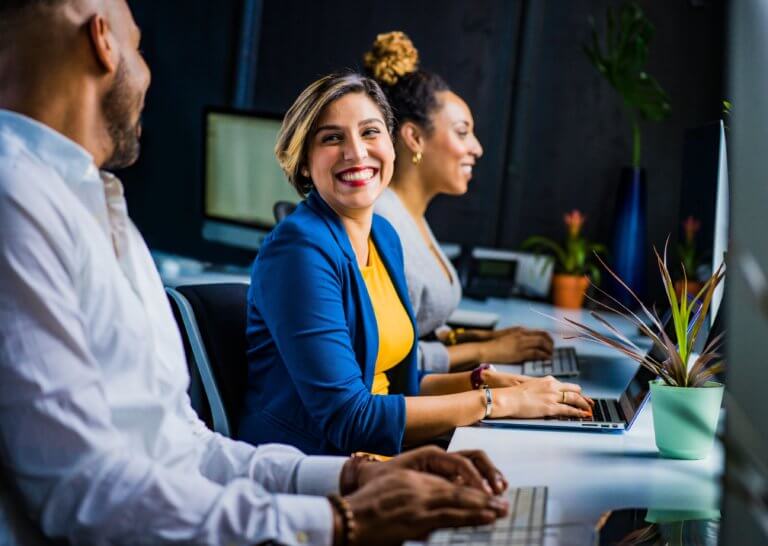 three business professionals working at laptops