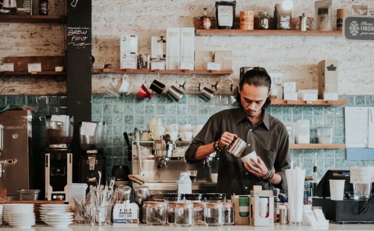 barista making coffee in a cafe